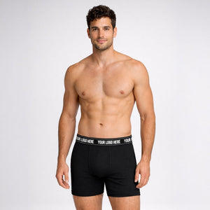 Man wearing black boxer briefs with customizable waistband on a white background